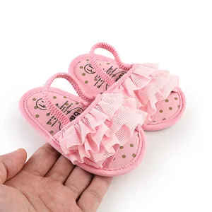Detail shot of pink ruffle baby walking shoes with soft elastic heel strap for infants