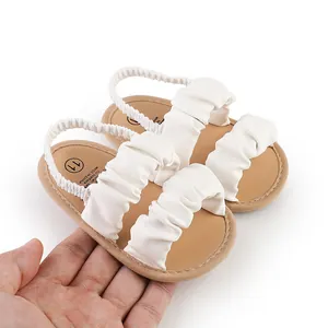 Close-up of white cloud pleated infant sandals with soft elastic backstrap