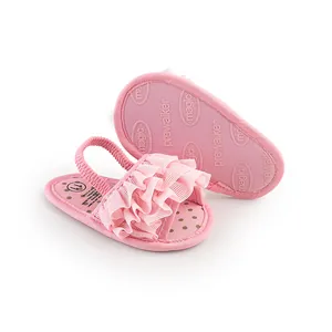 Macro view of pink ruffled baby prewalker shoes with polka dot insole and sole