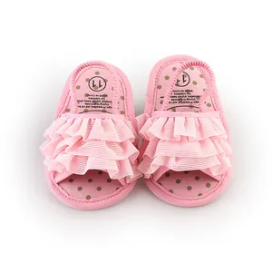 Detailed view of pink ruffled baby prewalker sandals with polka dot insoles