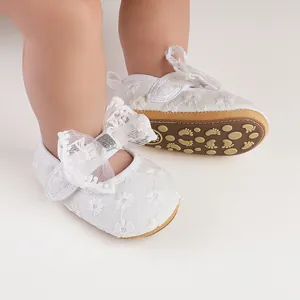Detail of white lace baby princess walker shoes with bow and anti-slip soft sole