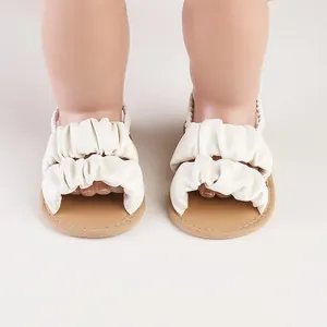 Detailed view of soft white ruffled infant girl sandals for summer outdoor walking