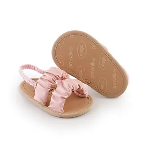 Soft pink ruched baby girl pre-walker sandals with anti-slip embossed magic sole detail.