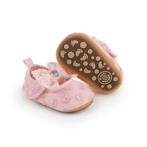 Close-up detail of pink baby princess shoes featuring lace bow and soft anti-slip sole.
