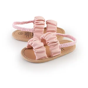 Detailed view of pink ruffled leather straps on soft-soled baby girl summer walker sandals