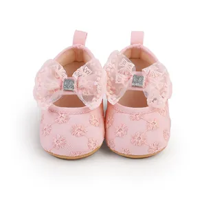 Detailed macro view of pink lace baby princess shoes with daisy embroidery and bow