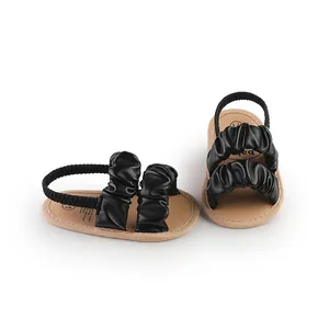 Detail shot of black ruched cloud straps on soft sole summer baby walking sandals