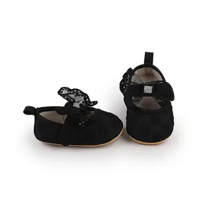Close-up view of black lace baby girl walker shoes with decorative butterfly bow
