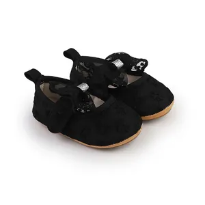 Detailed view of black baby girl lace bow walking shoes with soft soles and flowers