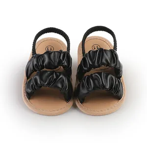 Soft sole black baby girl sandals with ruffled straps and elastic back strap detail