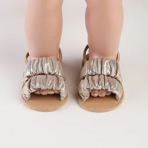 Detail view of gold ruffled baby girl summer walker shoes with elastic back strap