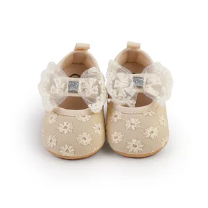 Detailed front view of cream lace baby princess shoes with large decorative mesh bows