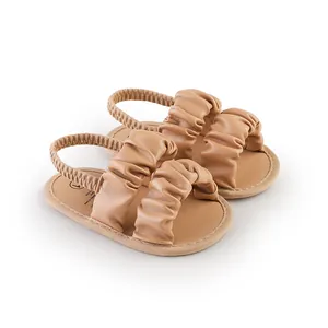Detailed view of khaki ruffled baby girl summer walking shoes with elastic strap.