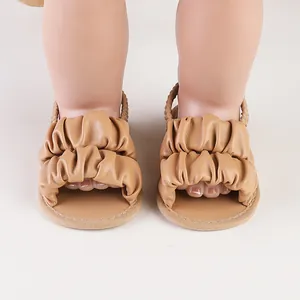 Detailed view of fashionable ruffled tan leather summer walking shoes for baby girls