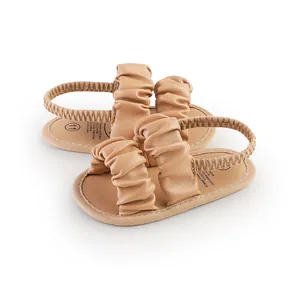 Detailed view of ruched beige baby girl summer walking sandals with elastic back strap
