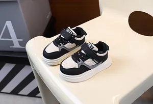 Detailed view of kids' thick-soled sneakers in black and white quilted pattern