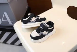 Detailed macro view of stylish quilted children sneakers in black and cream colors