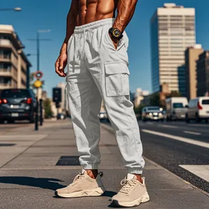 Detailed side view of men's white cotton linen cargo joggers on model in urban setting.