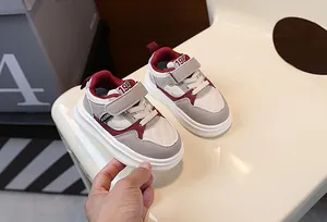 Close-up of children's thick-soled sneakers with burgundy and grey quilted design.