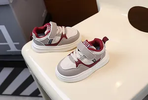 Close-up of children's thick-soled sneakers in a stylish maroon and beige colorway