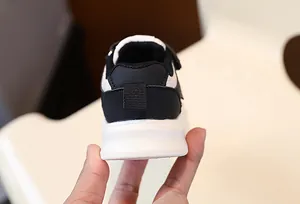 Detailed back view of black and white children's casual sneaker heel with thick sole