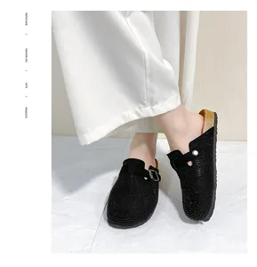 Detailed view of women's black rhinestone platform mules with adjustable buckle strap