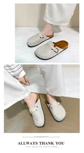Fashionable closed-toe rhinestone mules with cork sole shown on model in a studio setting.