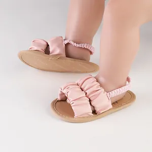 Detail view of pink ruffled cloud design baby sandals with soft elastic heel strap