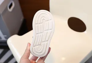 Detailed macro view of children's sports shoe anti-slip white sole with size 22.