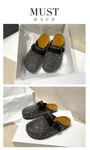 Sparkly black rhinestone studded closed-toe mules with cork soles in gift box packaging