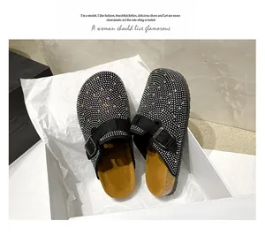 Macro view of black platform mules featuring a full coverage of sparkling rhinestones