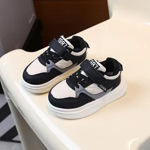 Stylish black and white children's thick-soled sneakers with quilted detail, casual style.
