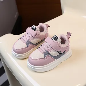 Fashionable pink and cream kids sneakers with durable thick soles and adjustable straps