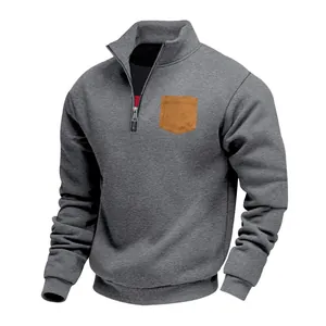 Casual men's grey half-zip fleece sweatshirt featuring a contrast tan chest pocket