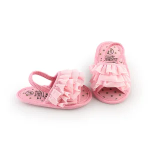 Close-up of pink ruffle baby pre-walker shoes with polka dot insole.