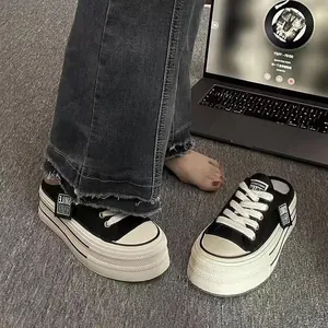Detailed view of black platform mules with white laces and thick soles for summer