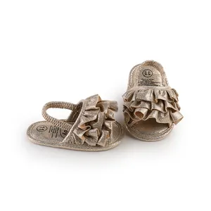 Detailed view of shimmering gold ruffled baby walking shoes with elastic heel strap