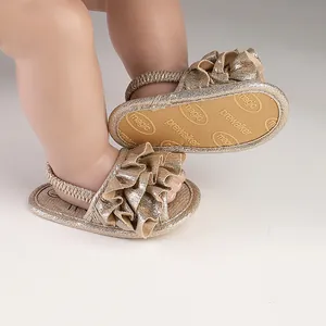 Detailed view of champagne gold baby prewalker sandals with elegant ruffles and non-slip sole