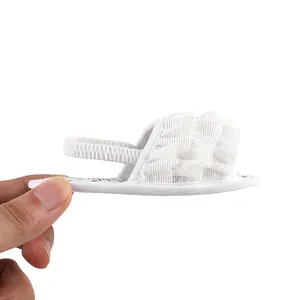 Detailed side view of white ruffled summer sandals for infant girl walking steps