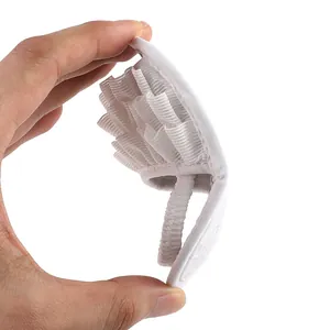 Close-up of a white ruffled baby sandal featuring a comfortable elastic heel strap.