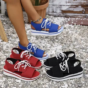 Stylish lace-up platform sandals for women in blue, red, and black on a gravel background