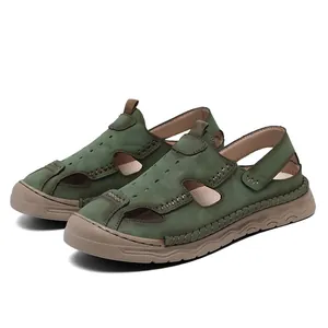 Macro view of men's green leather closed-toe breathable beach sandals for summer.