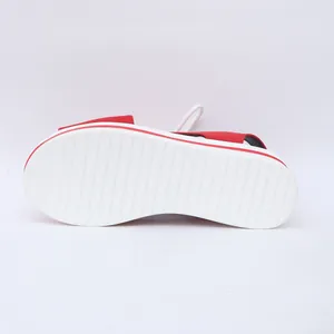 Close-up view of the anti-slip white ribbed sole on red women's platform beach sandals