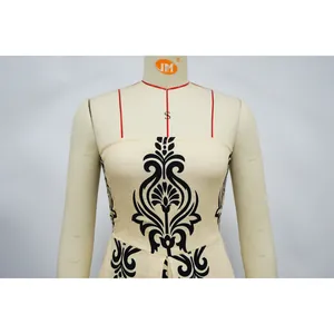 Detail view of a strapless beige jumpsuit with symmetrical black baroque print.