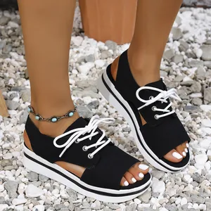 Stylish black platform peep-toe sandals with white laces for a trendy summer beach look