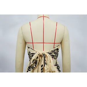 Back view detail of printed strapless jumpsuit featuring a stylish large bow tie knot