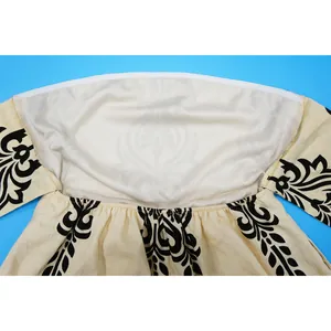 Detail view showing inner lining and black damask print of strapless women's romper