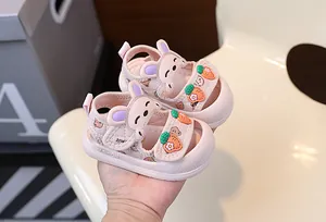 Détail de sandales roses respirantes pour bébé avec breloques mignonnes lapin et carotte