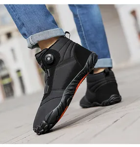 Side view detail of black high-top warm outdoor boot with rotary lacing system dial.