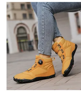 Detailed view of yellow high-top fleece-lined snow boots with rotary dial laces system